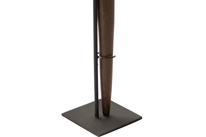 Metal base of the decorative stand figure providing stability and contrast.