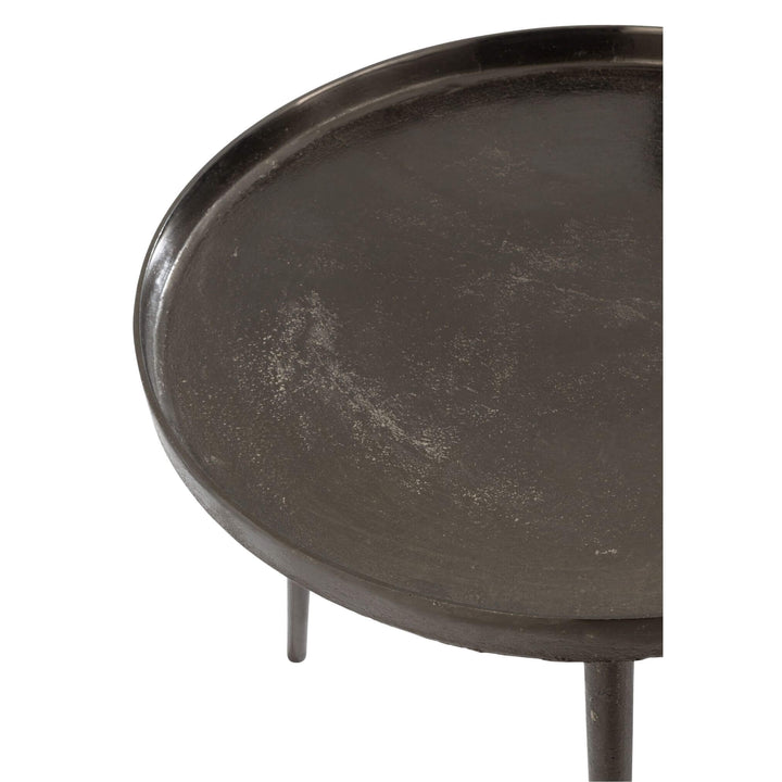 Close-up of raised-edge round top on black iron coffee table