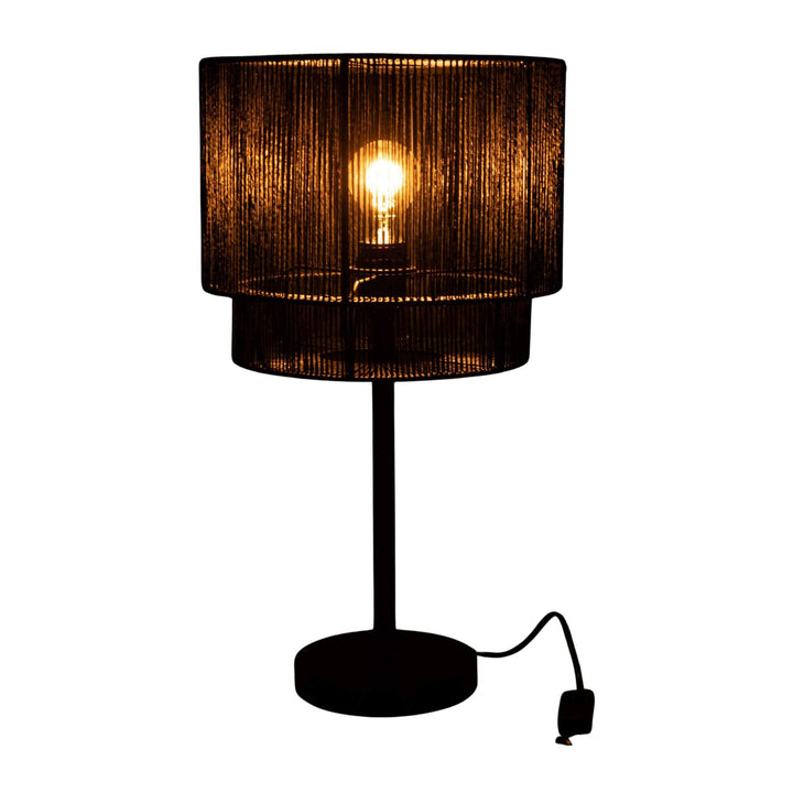 Nero Table Lamp with round base and textured shade at night