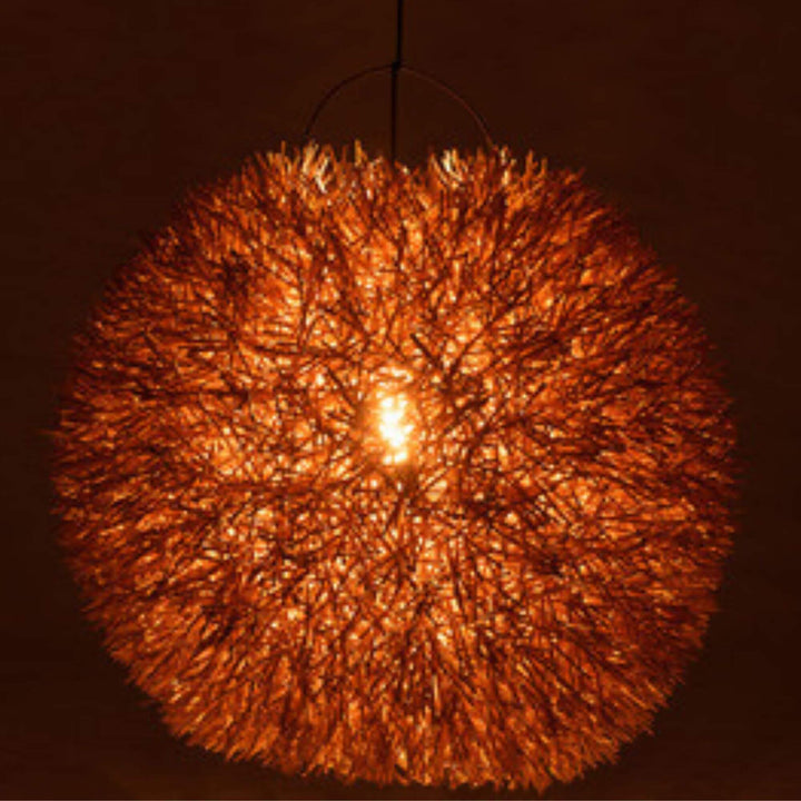 Nest Ceiling Lamp illuminated, radiating warm light through natural fibers.