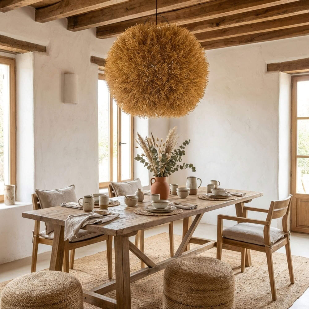 Dining area with Nest ceiling lamp and a table with chairs, decorative elements, and a view of the sea.