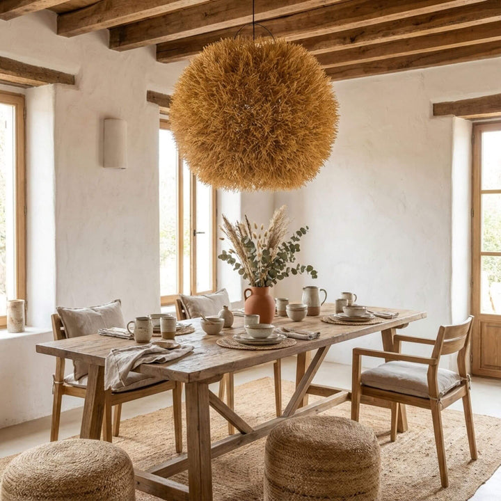 Dining area with Nest ceiling lamp and a table with chairs, decorative elements, and a view of the sea.