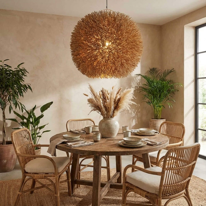Dining area with Nest ceiling lamp and a table with chairs, decorative elements, and a view of the sea.