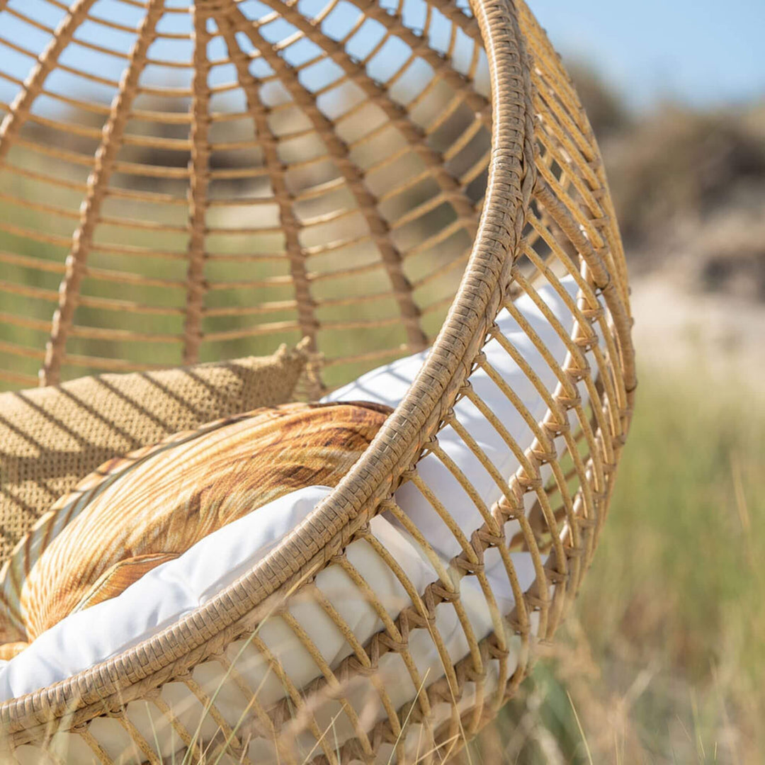 Outdoor scene featuring the Nest Hanging Chair in a natural setting.
