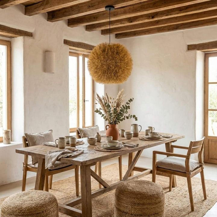 Dining area with Nest ceiling lamp and a table with chairs, decorative elements, and a view of the sea.
