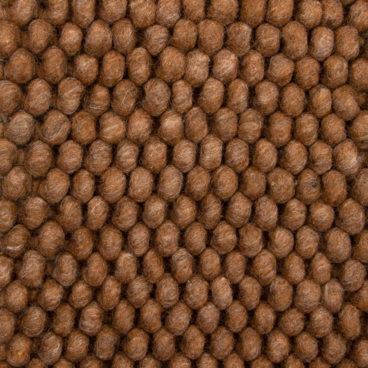 Close-up of the wool–viscose looped weave showing depth and natural fiber detail.