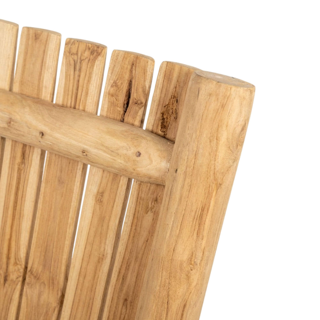 Detail view of the headboard corner showing the teak branch construction and wood grain.