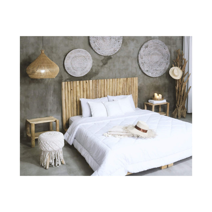 Handcrafted teak branch headboard highlighting organic texture and natural tones.