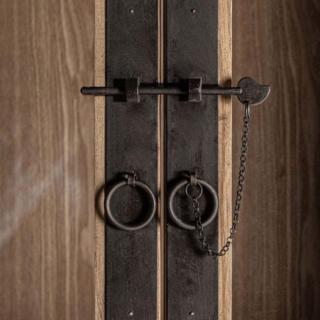 Close-up of the metal hardware and glass detailing on the Nilo Cabinet.