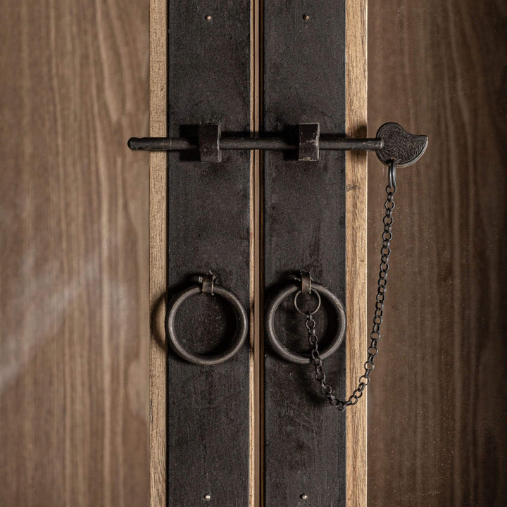 Close-up of the metal hardware and glass detailing on the Nilo Cabinet.