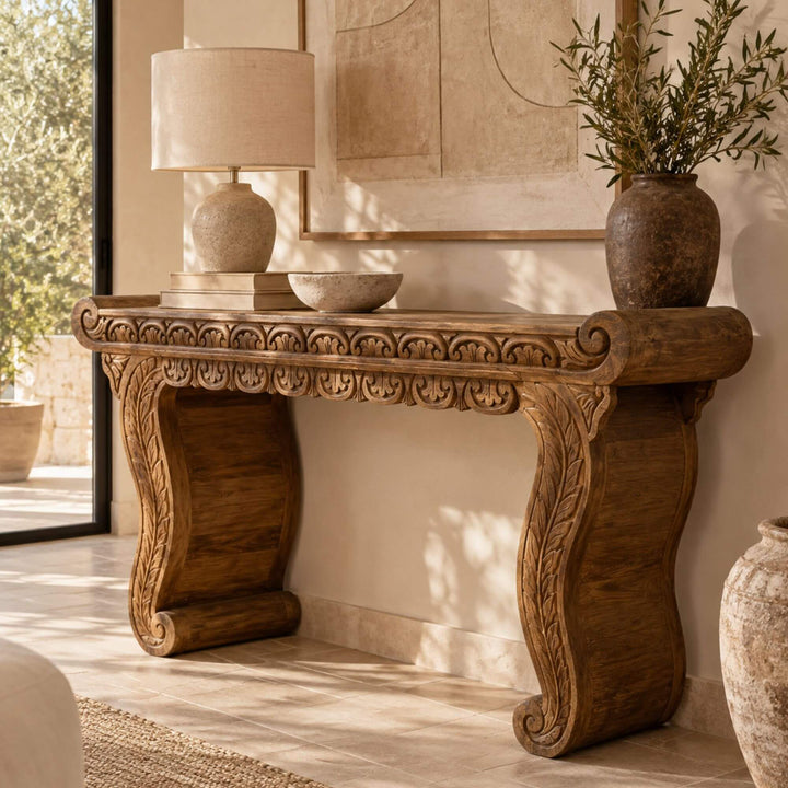 Nirvana carved teak wood console styled with lamps and decorative objects in a warm Mediterranean-inspired interior