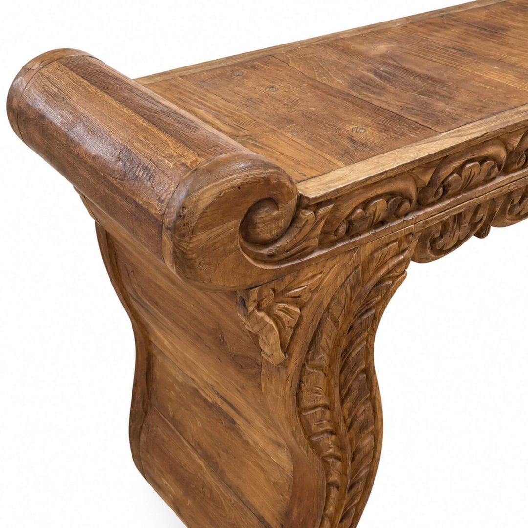 Close-up of the Nirvana console highlighting the ornate teak carving, curved edge, and expressive natural wood grain