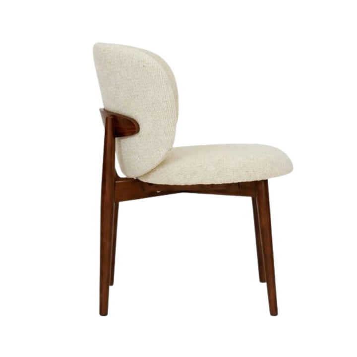 Side view of the dining chair highlighting its rounded backrest and elegant wood structure.
