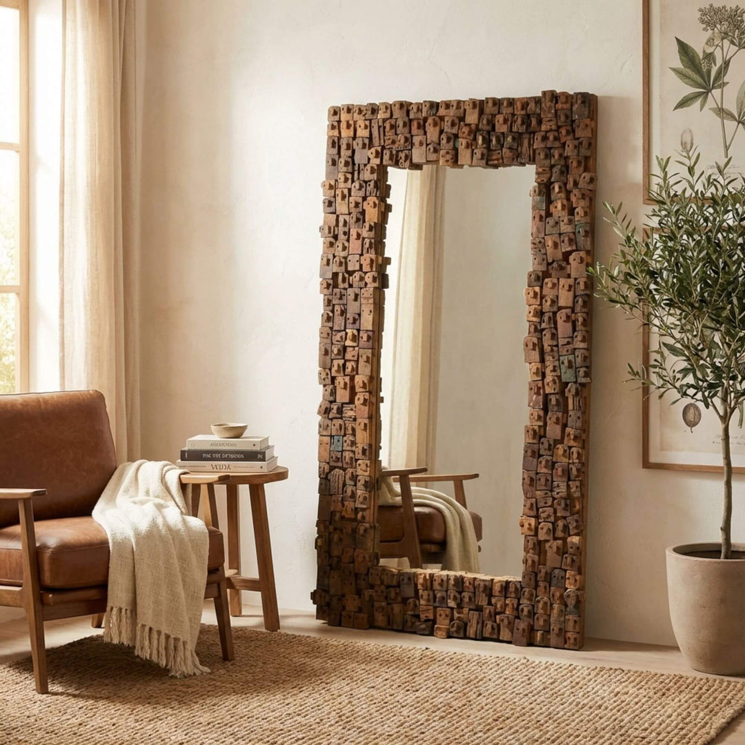 Decorative Nommo floor mirror with a unique wooden frame in a living room setting.