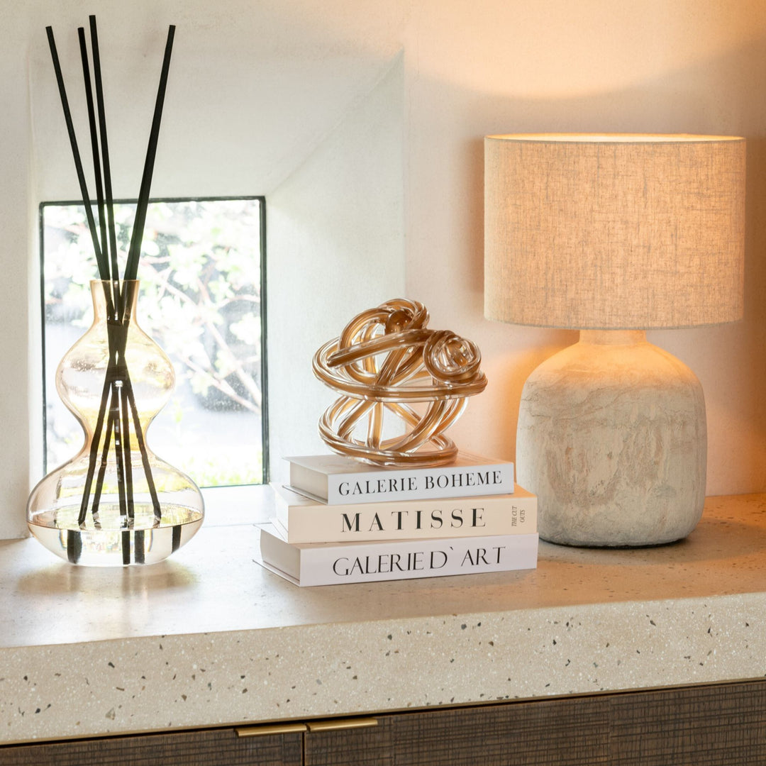 Nordic Vetiver Diffuser displayed on a console table within a warm, modern interior.
