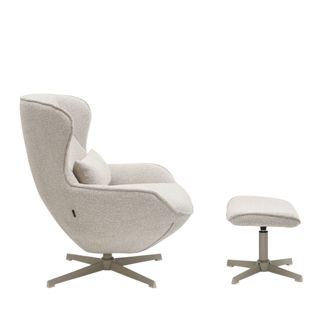 Side view of the Nuba Lounge Chair and footstool highlighting the curved silhouette.