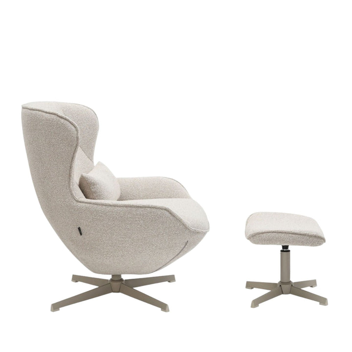 Side view of the Nuba Lounge Chair and footstool highlighting the curved silhouette.