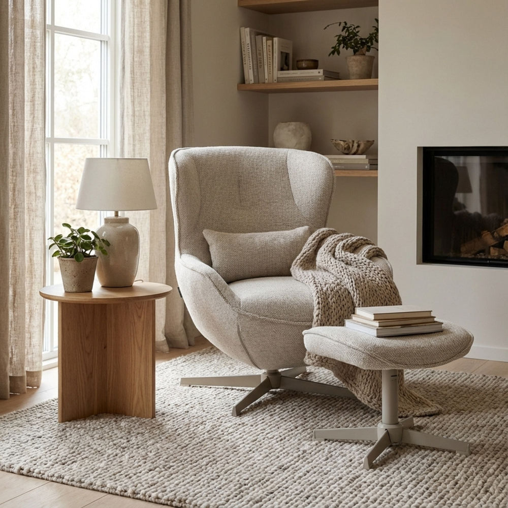 Styled living room setting featuring the Nuba Lounge Chair and footstool beside a wooden side table.
