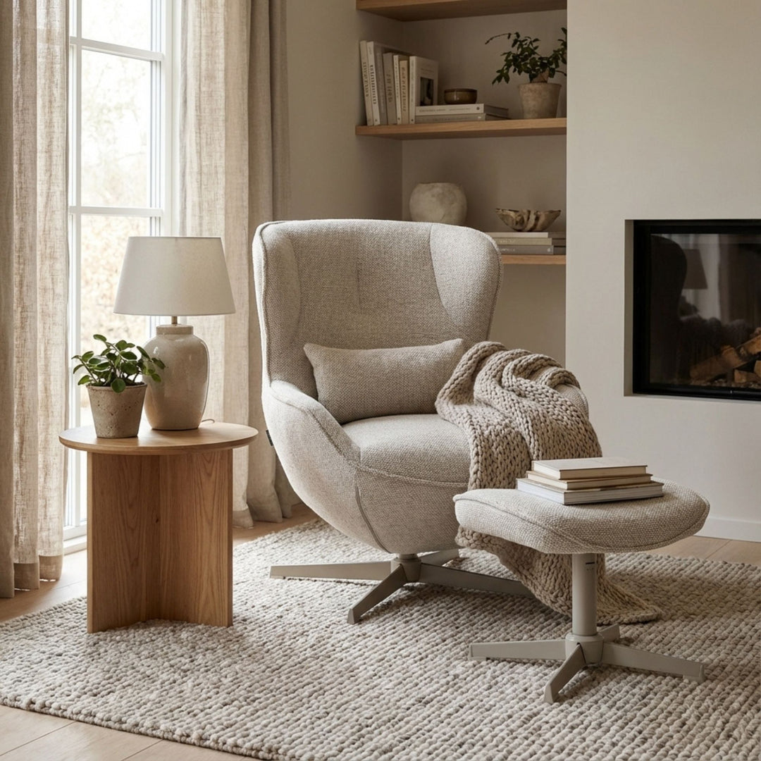 Styled living room setting featuring the Nuba Lounge Chair and footstool beside a wooden side table.
