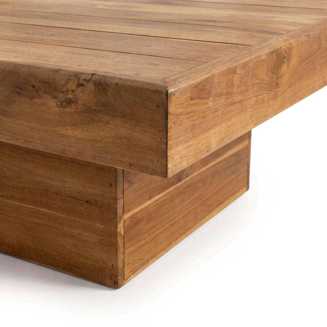 Close-up of the Oahu coffee table showing its thick teak wood top and architectural pedestal base