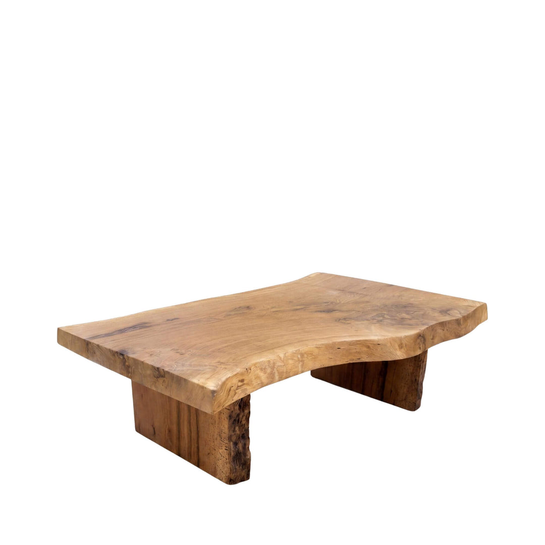 Front view of the oak coffee table showing its solid wood top, block legs, and organic shape.