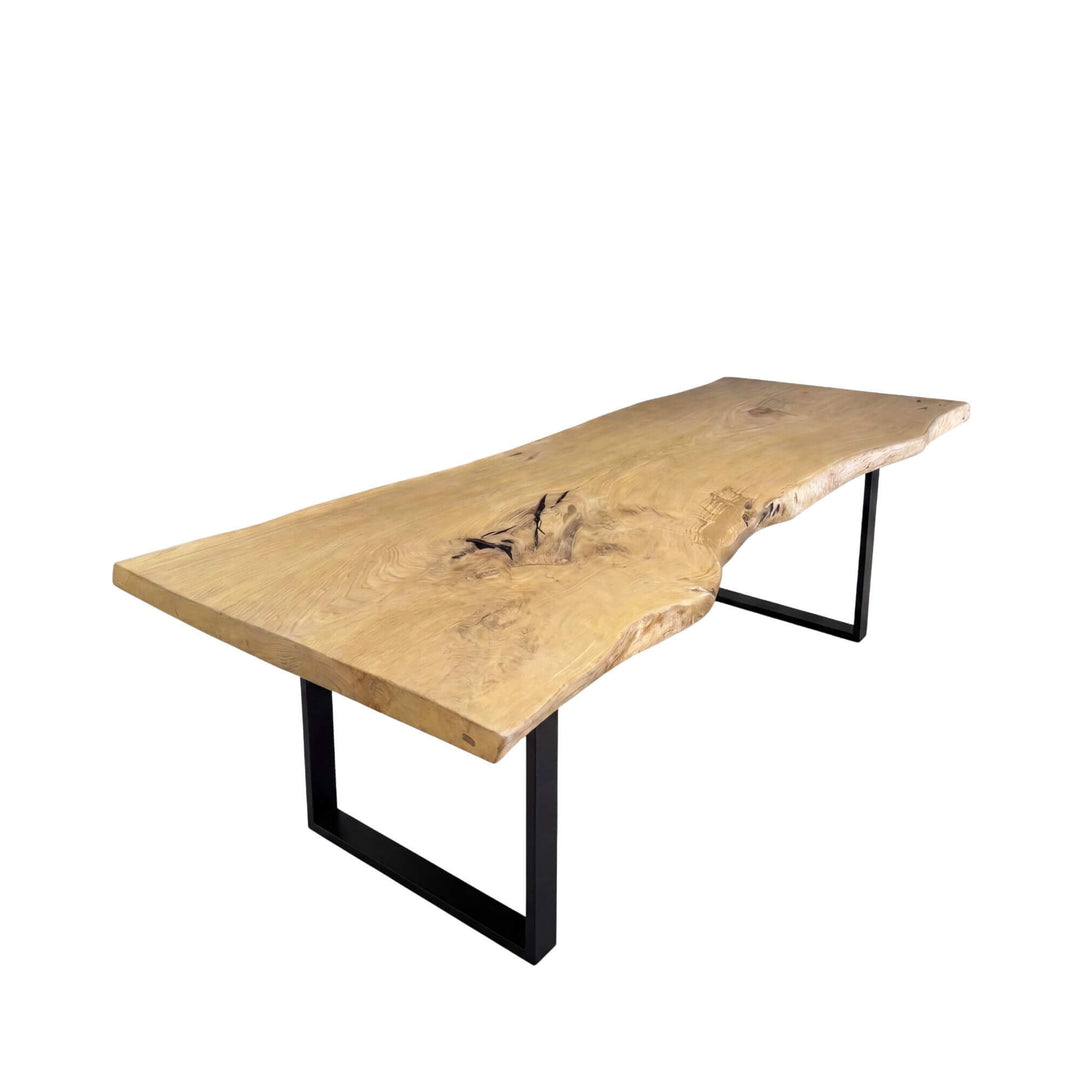 Front angled view of the oak dining table showing its natural live-edge top and black contemporary legs.