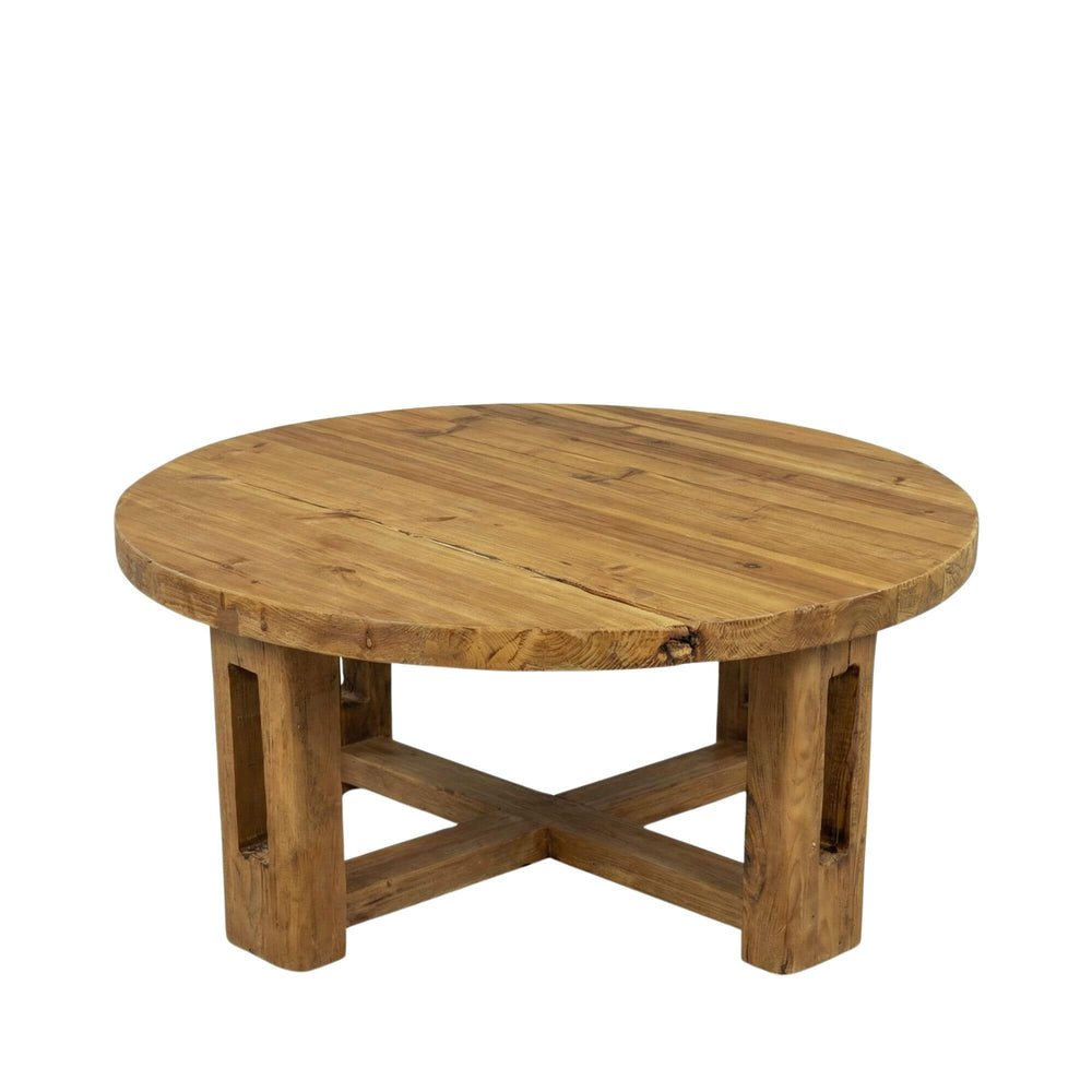 Front view of the Oak Sila round coffee table highlighting its cross-leg base and thick tabletop.