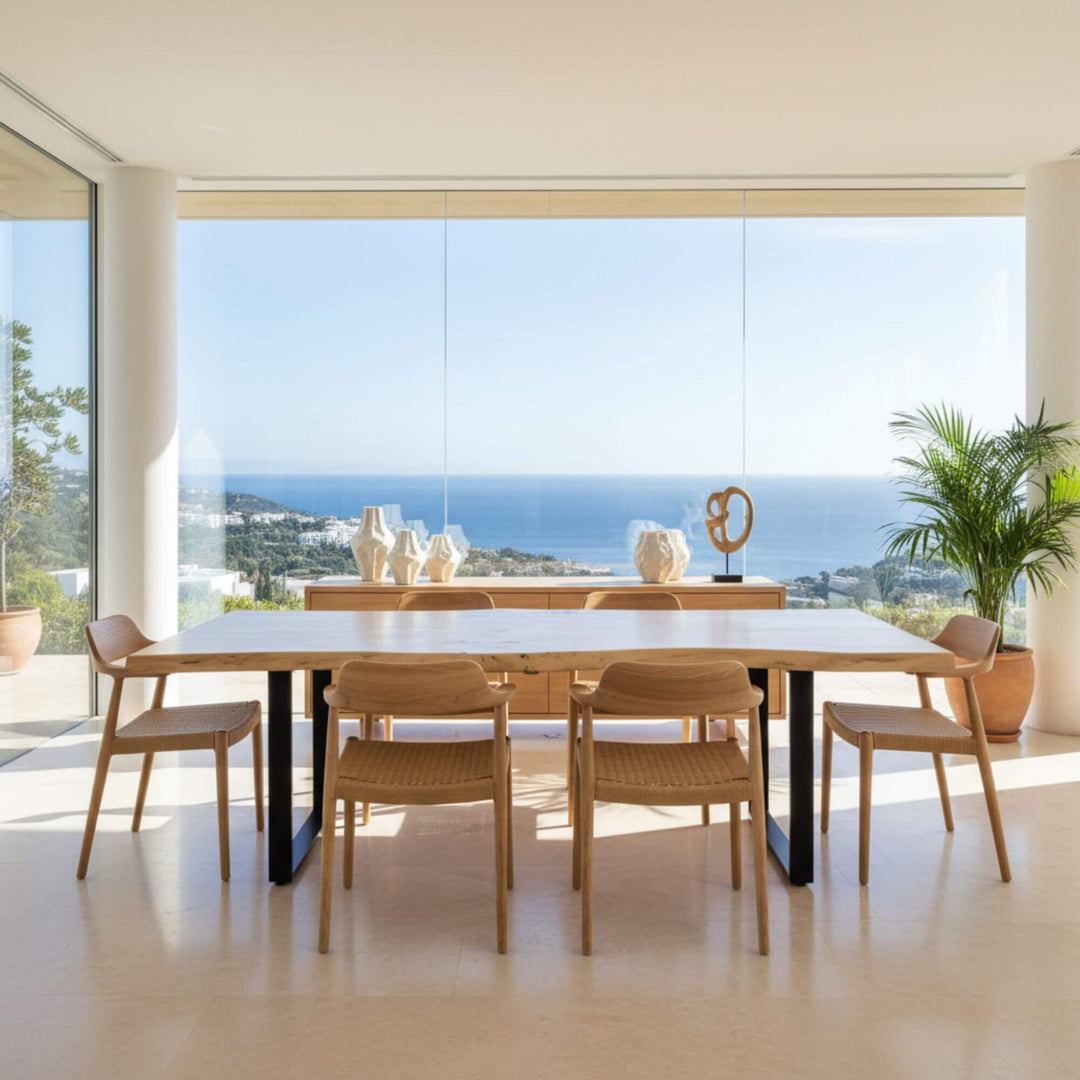 Oak Wood Dining Table in light oak displayed in a modern dining room with ocean views.
