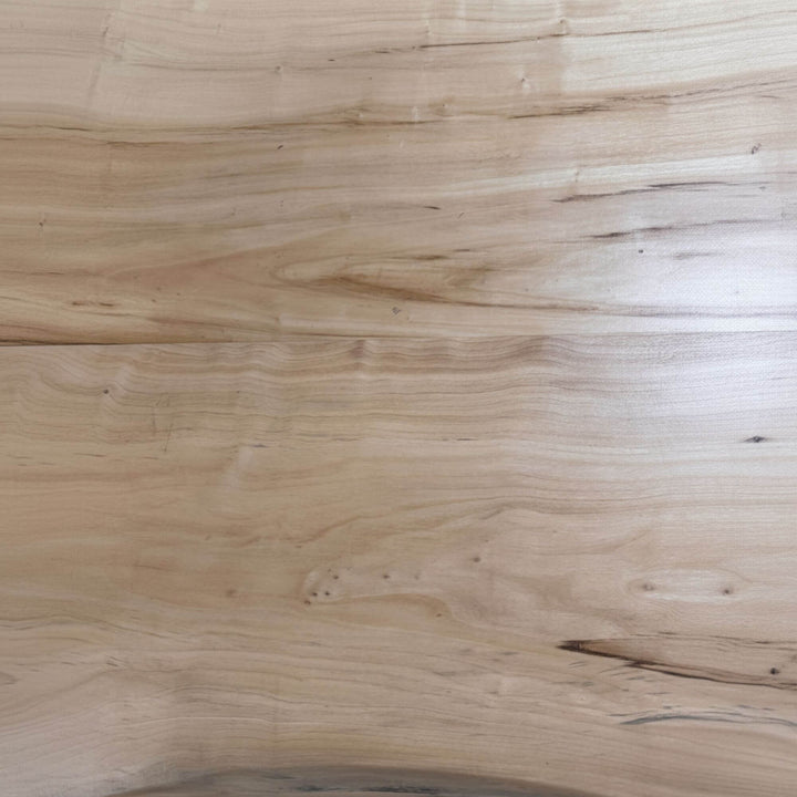 Detailed shot of the wood pattern and organic texture of the dining tabletop.
