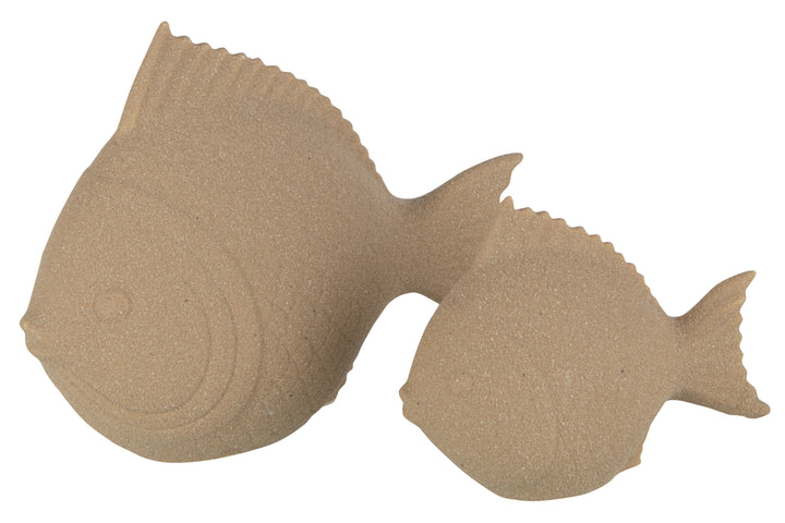 Angled view of the sand-colored porcelain fish showing its smooth sculptural form.