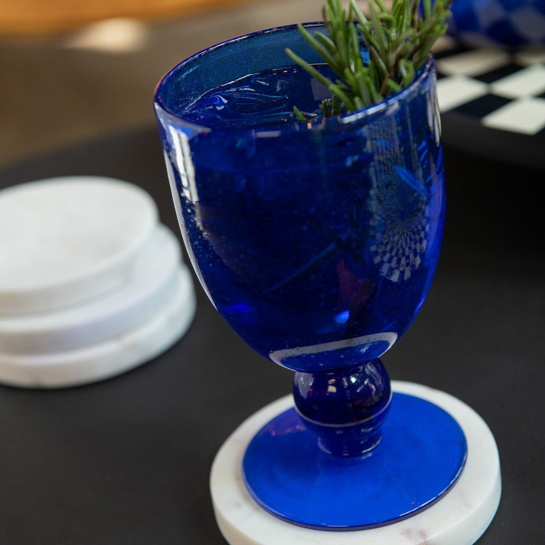 Ocean Cup filled and styled on a black tabletop with greenery garnish.