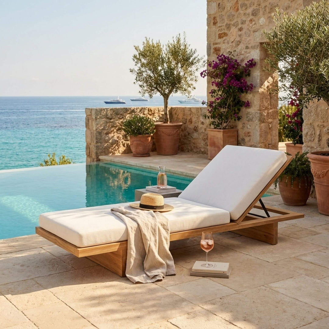 Ocume sunbed styled by a pool, showcasing its clean lines and natural wood finish.