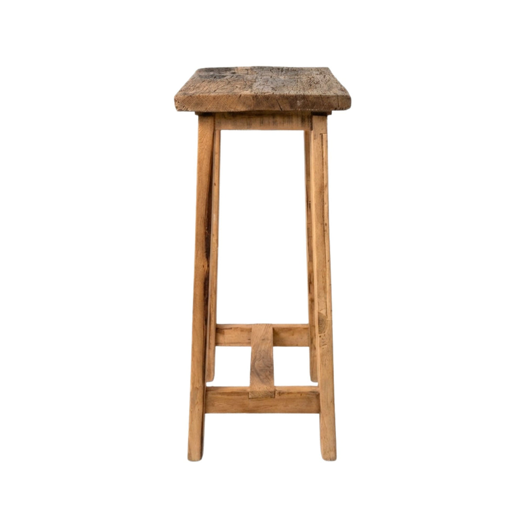 Side view of Old Bar Stool showing its simple structure and sturdy wooden legs.