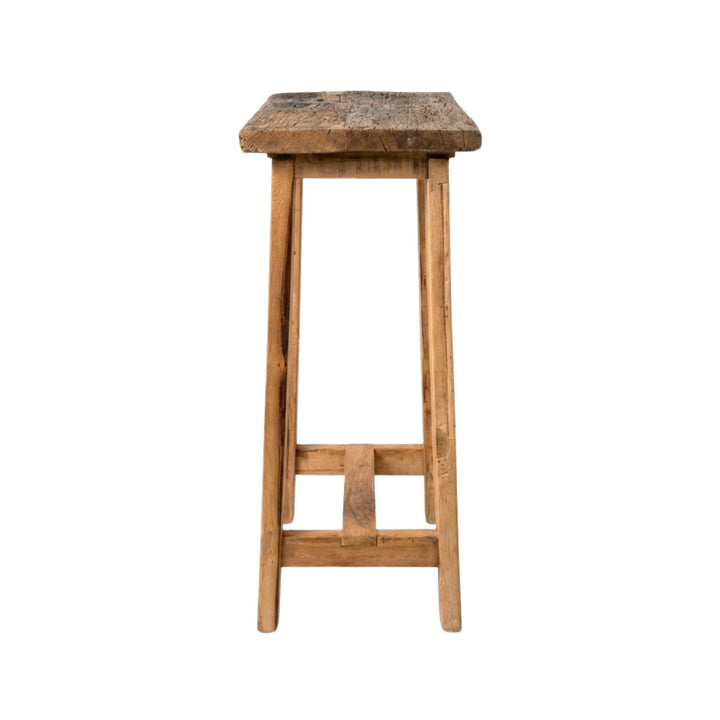 Side view of Old Bar Stool showing its simple structure and sturdy wooden legs.