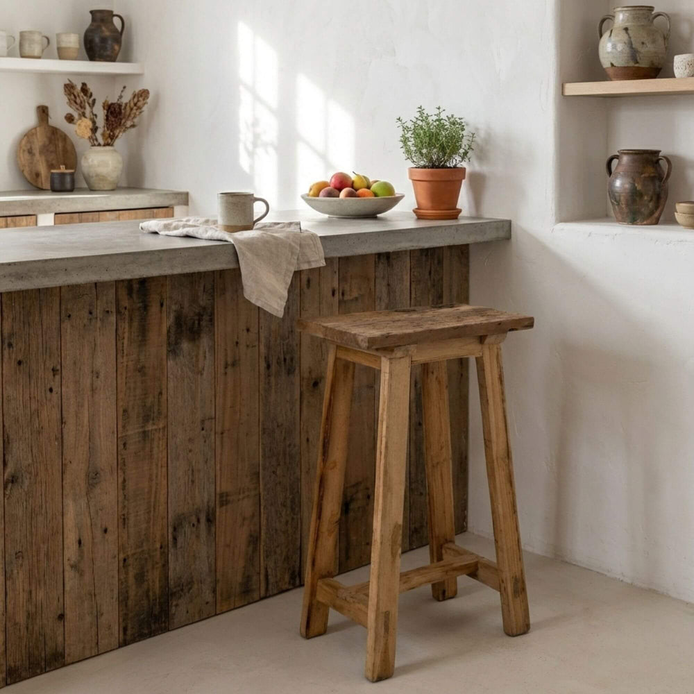 Styled interior view of Old Bar Stool placed at a kitchen counter, highlighting its natural wood character.