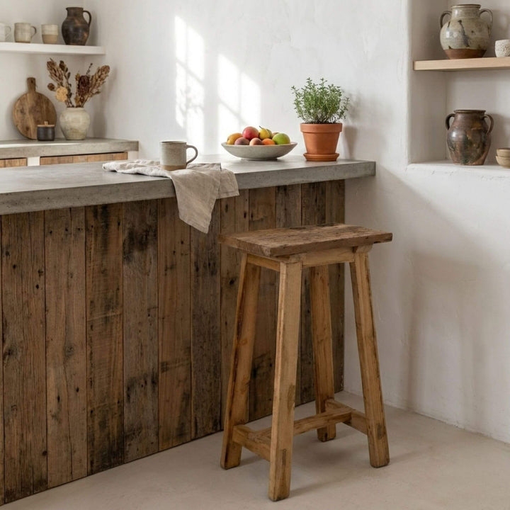 Styled interior view of Old Bar Stool placed at a kitchen counter, highlighting its natural wood character.