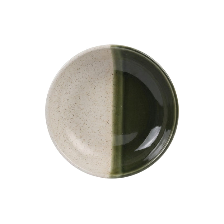 Top view of olive green ceramic soup plate with half-glazed design.