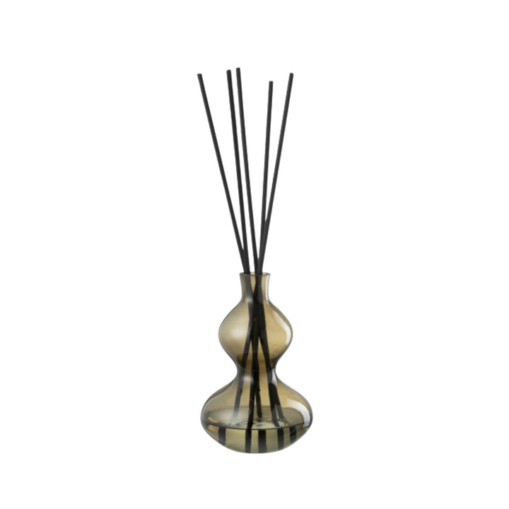 Small Olive & Frank diffuser highlighting its rounded glass shape and reeds.
