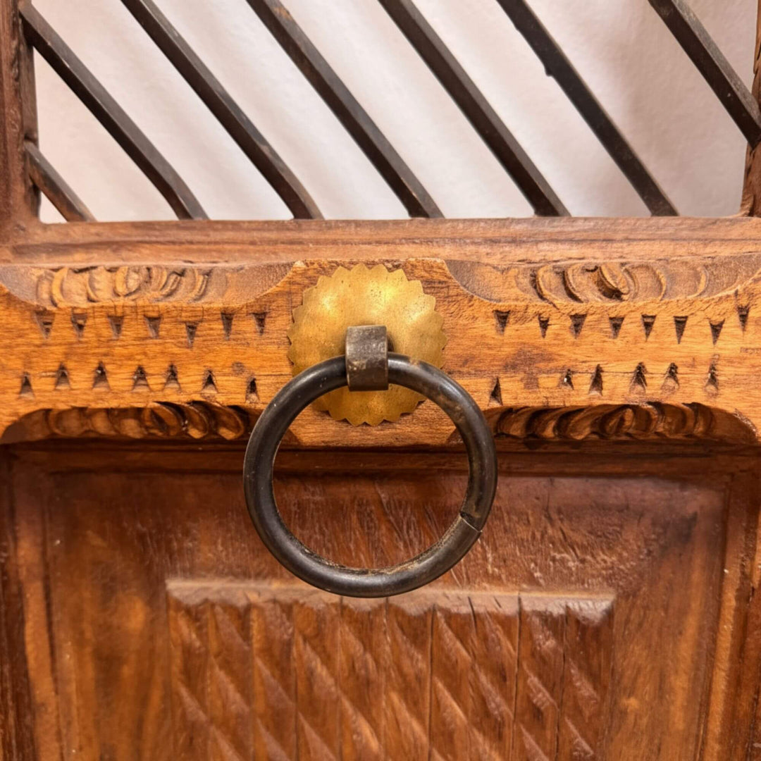 Detail of the antique-style metal ring handle on the sheesham window.