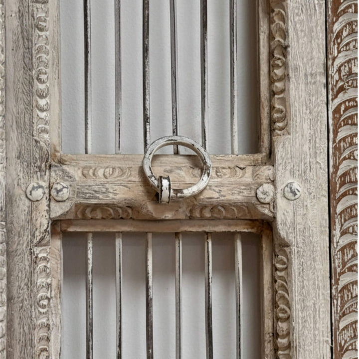 Close-up of carved frame details on the white wash Olmen Window.