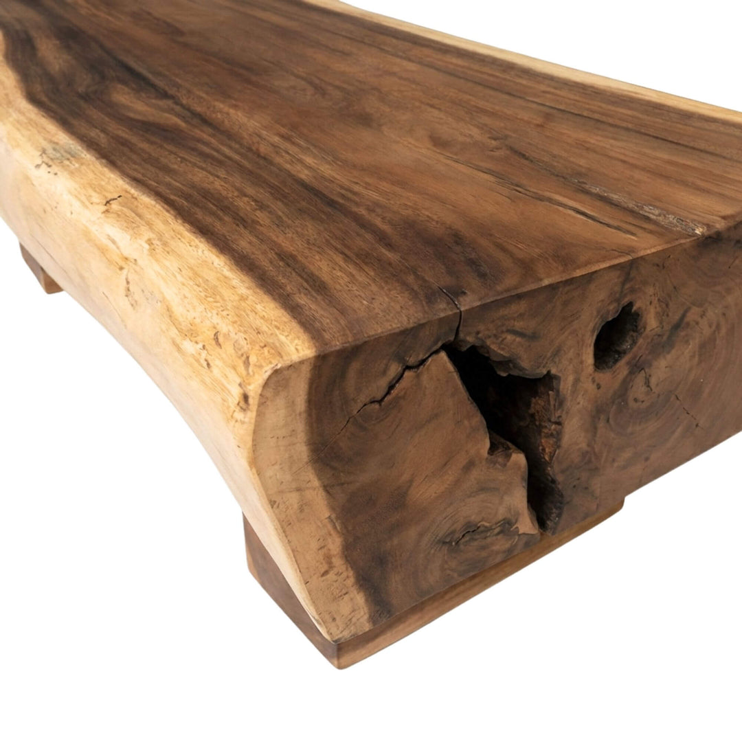 Side view highlighting the thick tabletop and sculptural wooden legs.