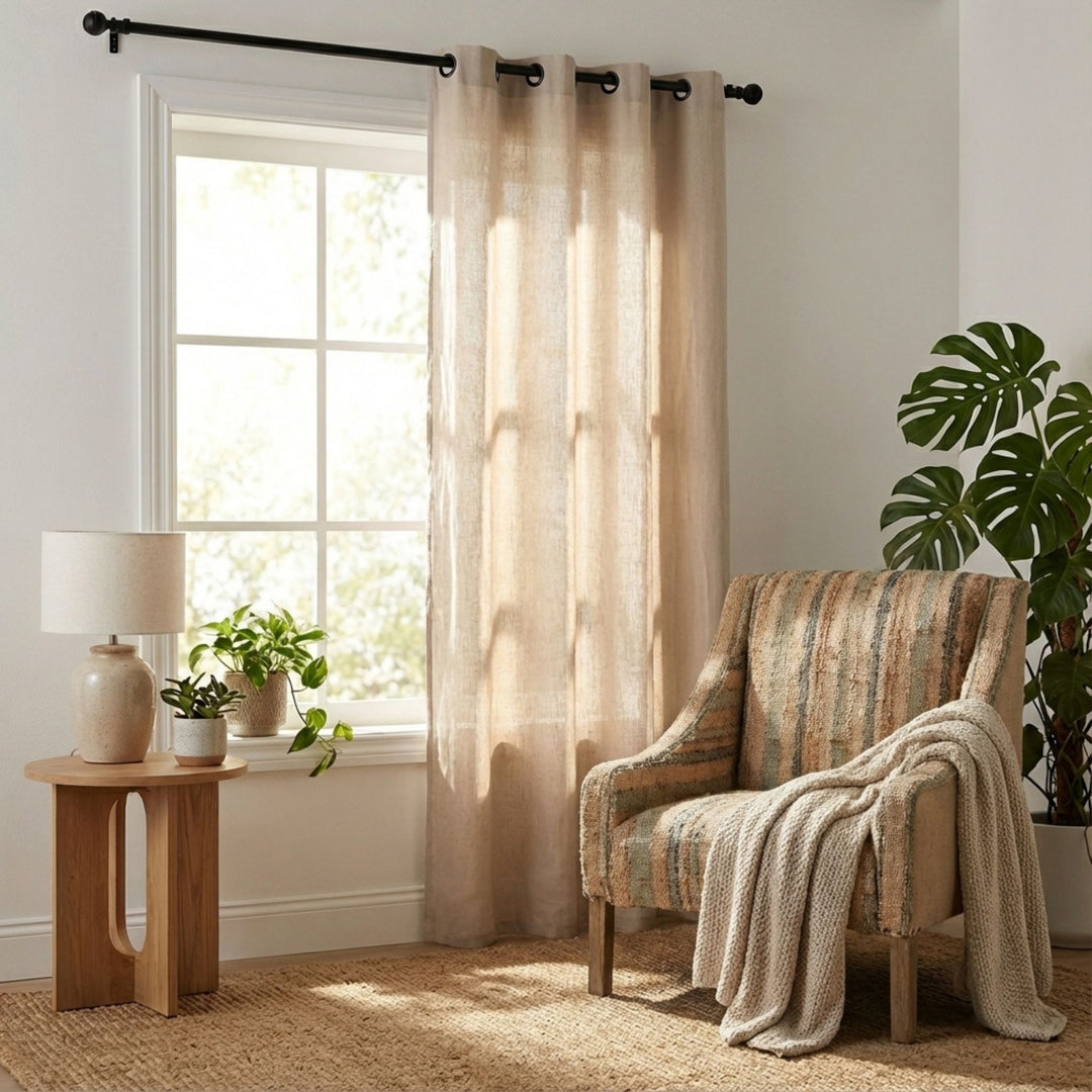 Living room setting featuring the Opera curtain softly filtering daylight through neutral fabric.