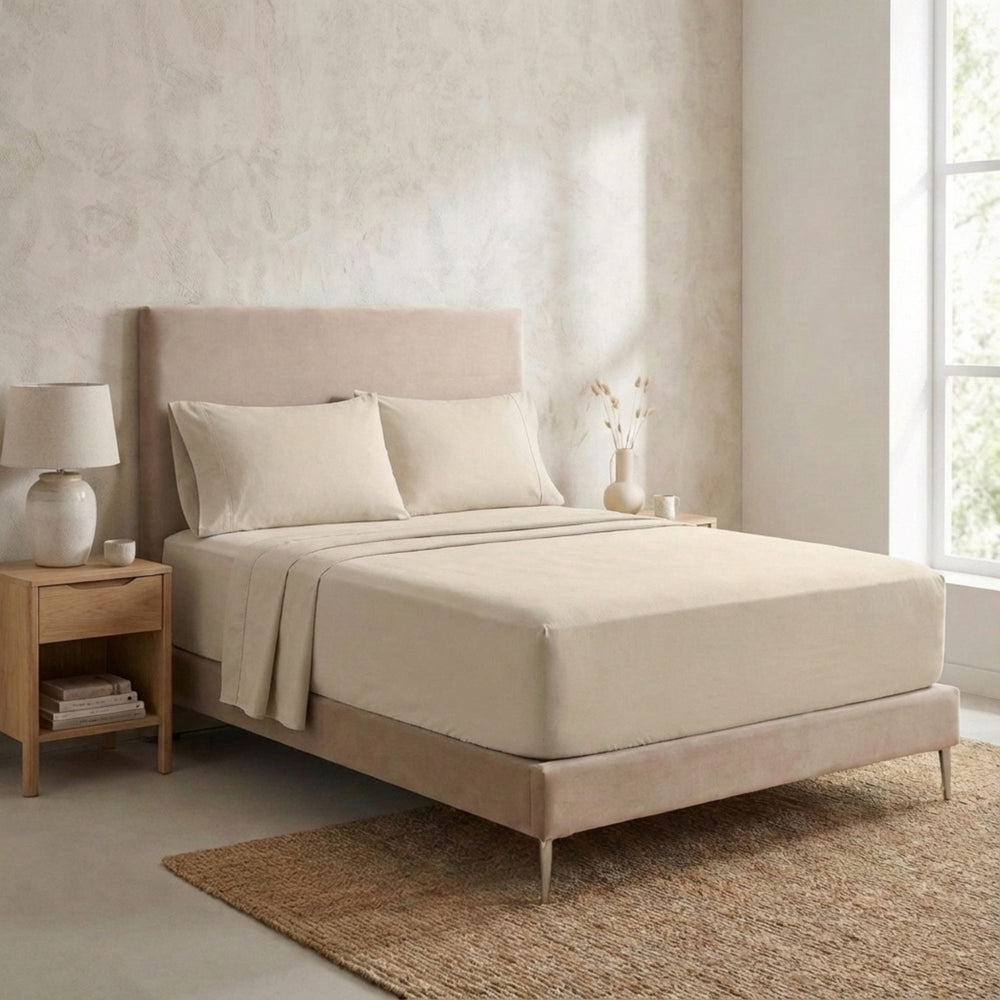 Bedroom setting featuring the Opera top sheet styled in a minimalist, natural interior.