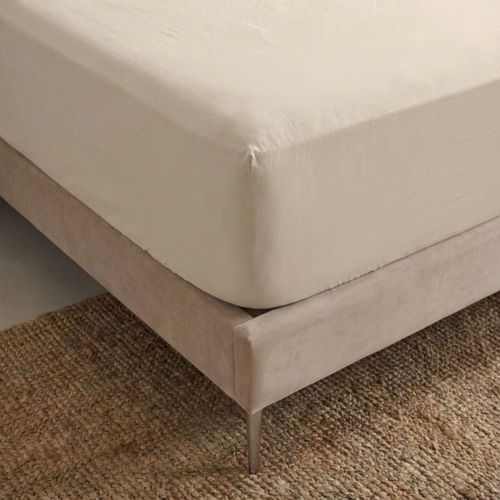 Close-up view of the Opera fitted sheet showing its smooth cotton-linen texture and tailored finish.