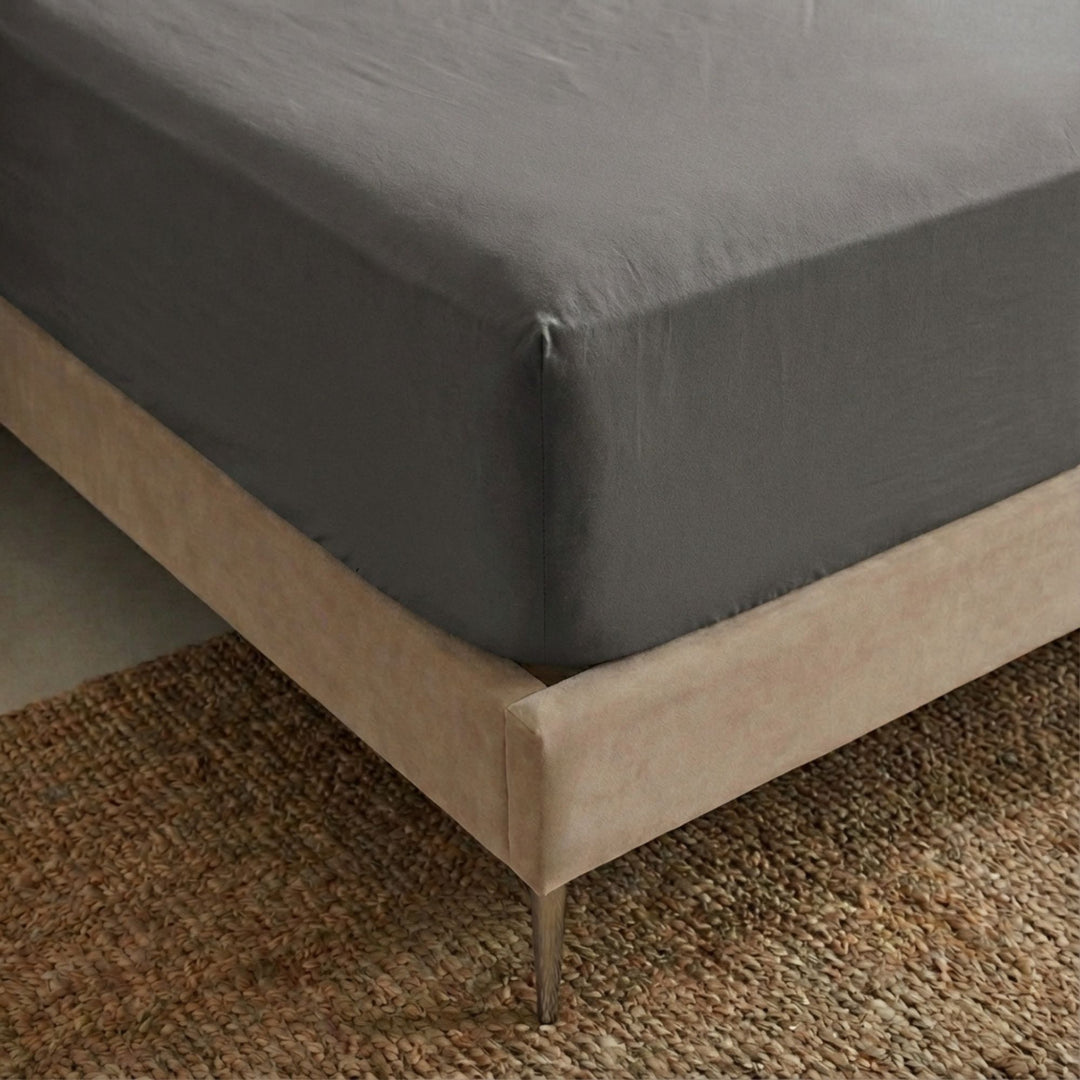 Close-up view of the Opera fitted sheet showing its smooth cotton-linen texture and tailored finish.
