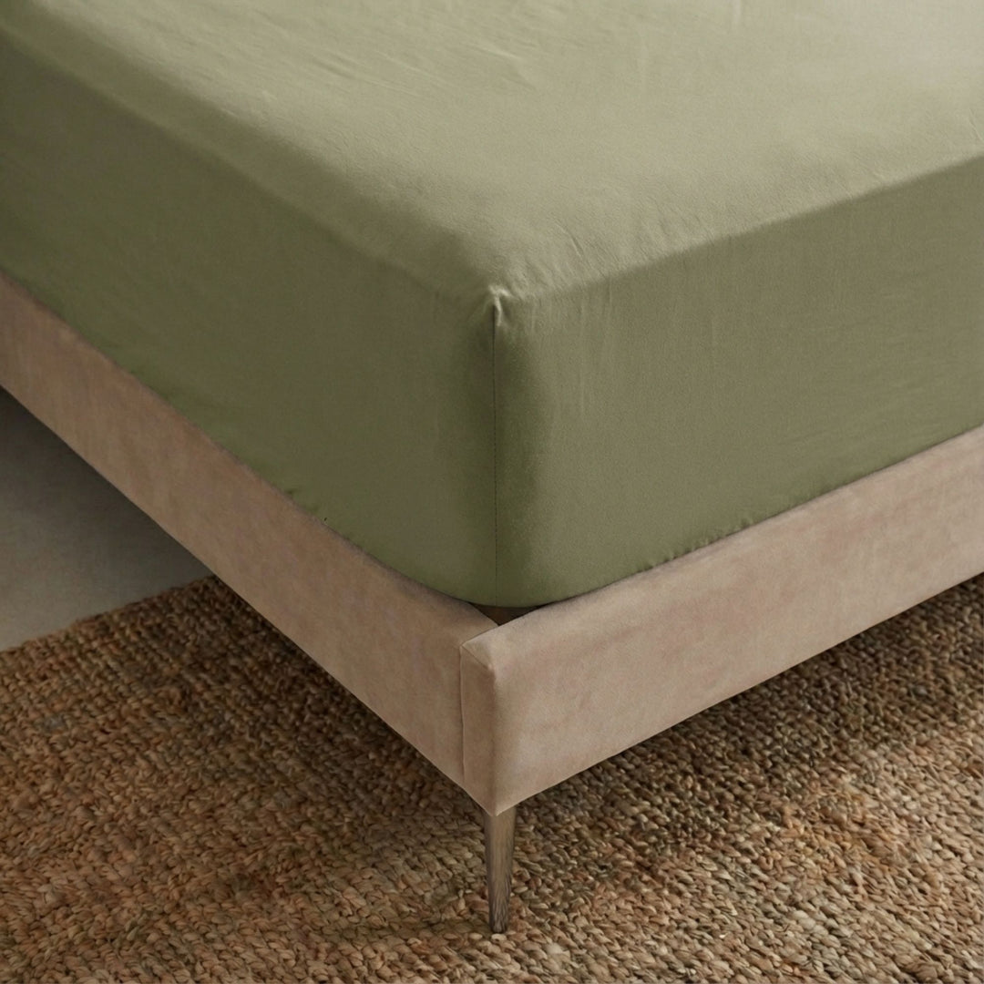 Close-up view of the Opera fitted sheet showing its smooth cotton-linen texture and tailored finish.