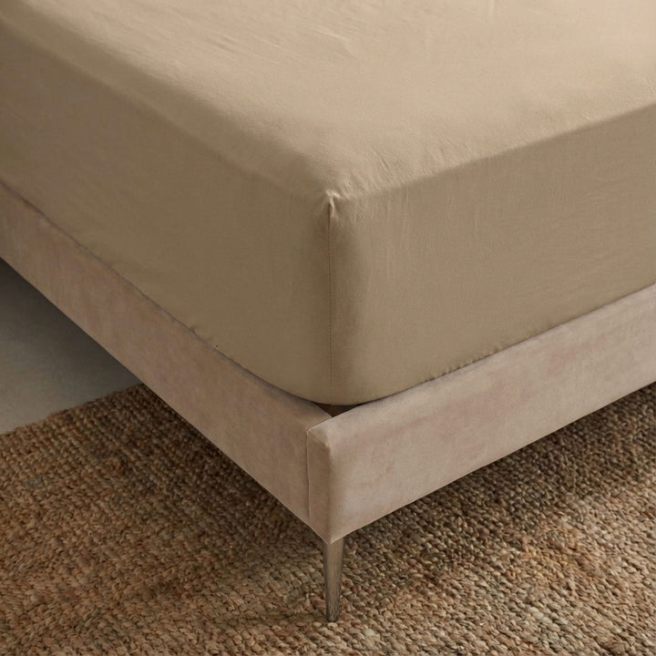 Close-up view of the Opera fitted sheet showing its smooth cotton-linen texture and tailored finish.