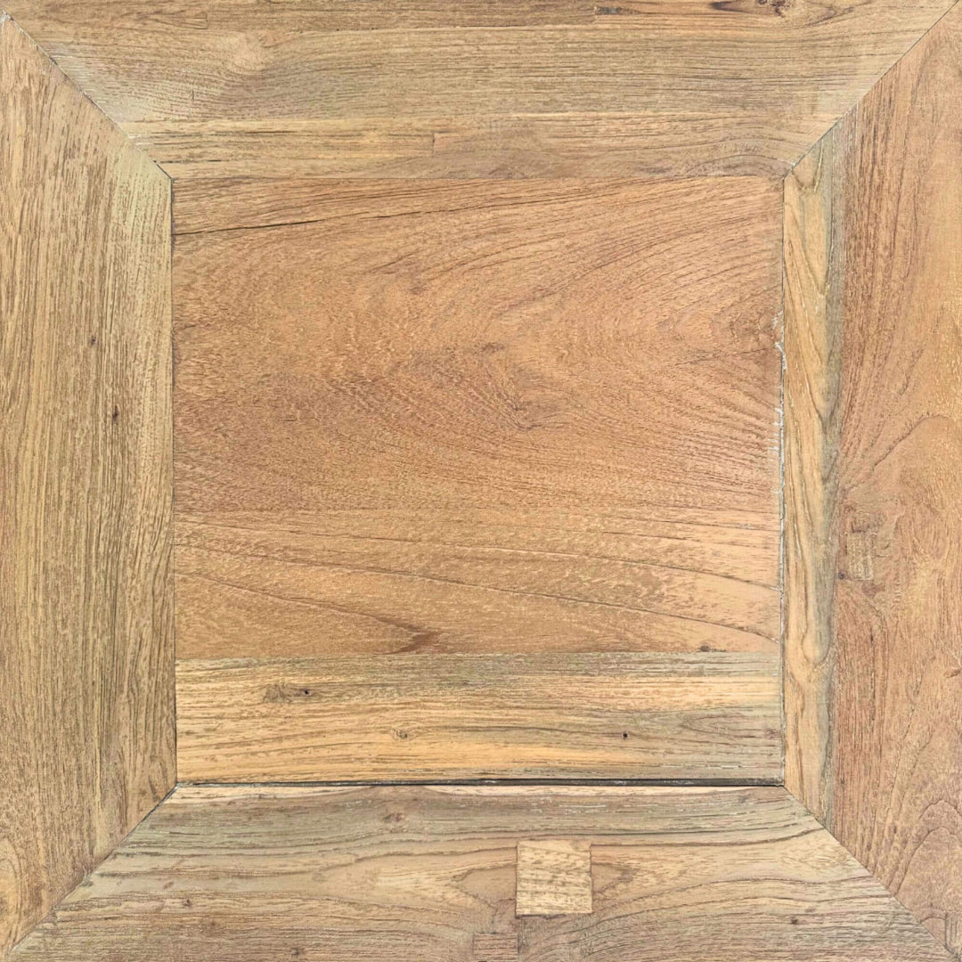 Close-up of the teak Opium Table showing curved leg detail and wood grain.