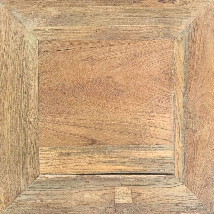 Close-up of the teak Opium Table showing curved leg detail and wood grain.