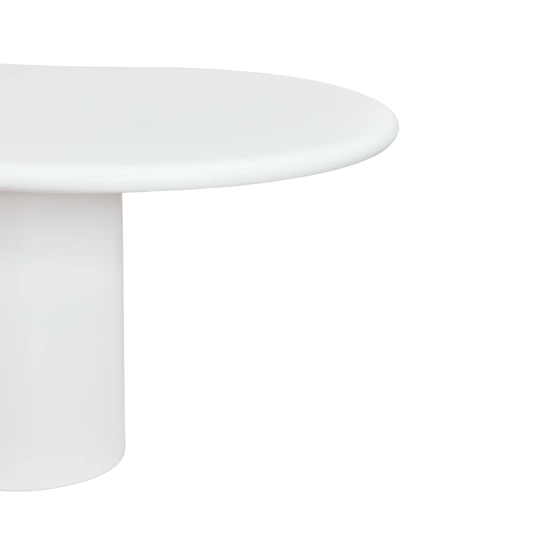 Close-up detail of the tabletop edge showing the smooth curved cement finish.